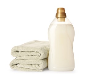 Photo of Bottle of fabric softener and stacked clean towels isolated on white