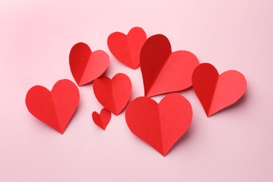 Photo of Paper hearts on pink background, flat lay