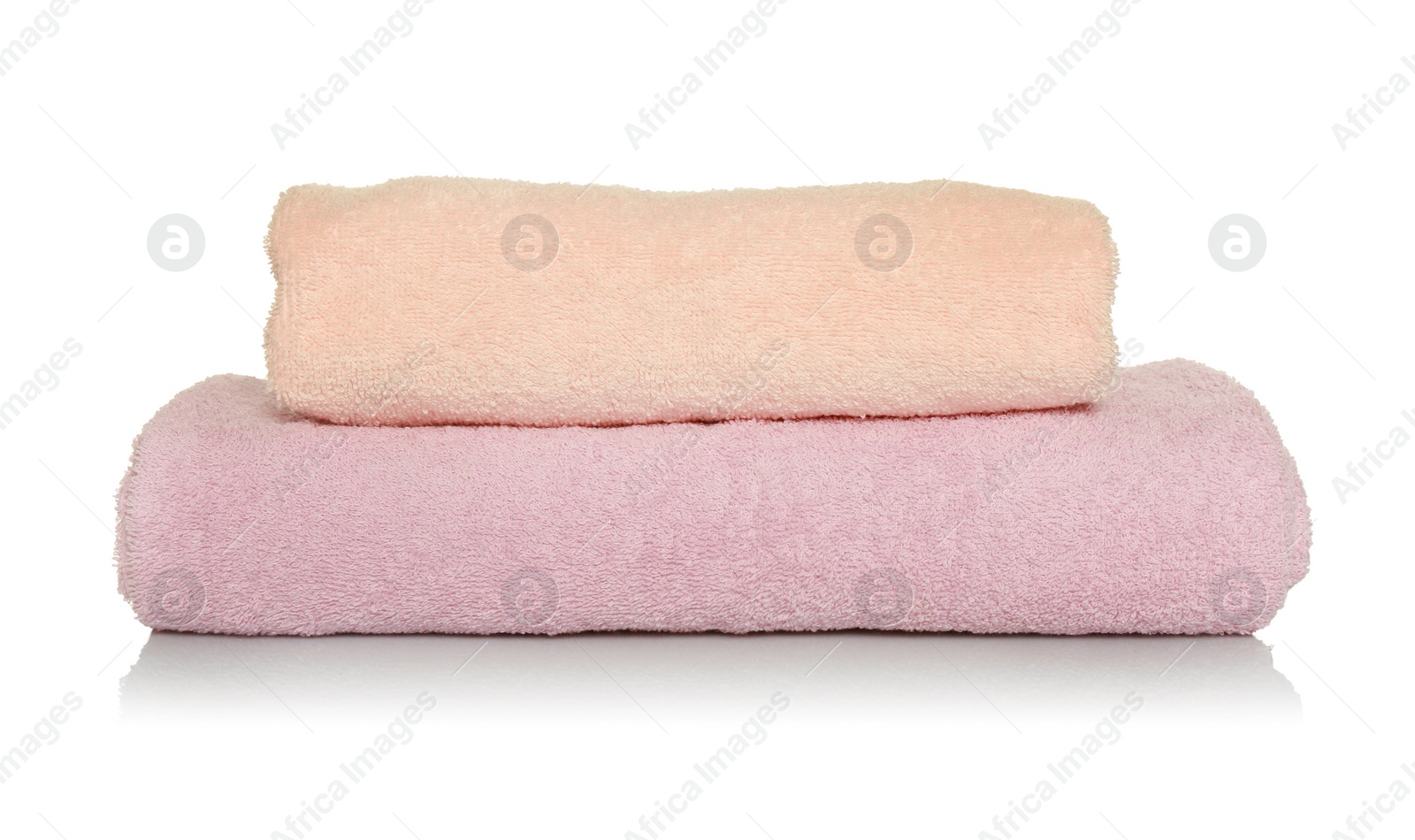 Photo of Folded soft terry towels on white background