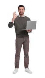 Photo of Handsome bearded businessman with laptop showing OK gesture on white background