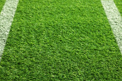 Image of Green grass with white markings, closeup view