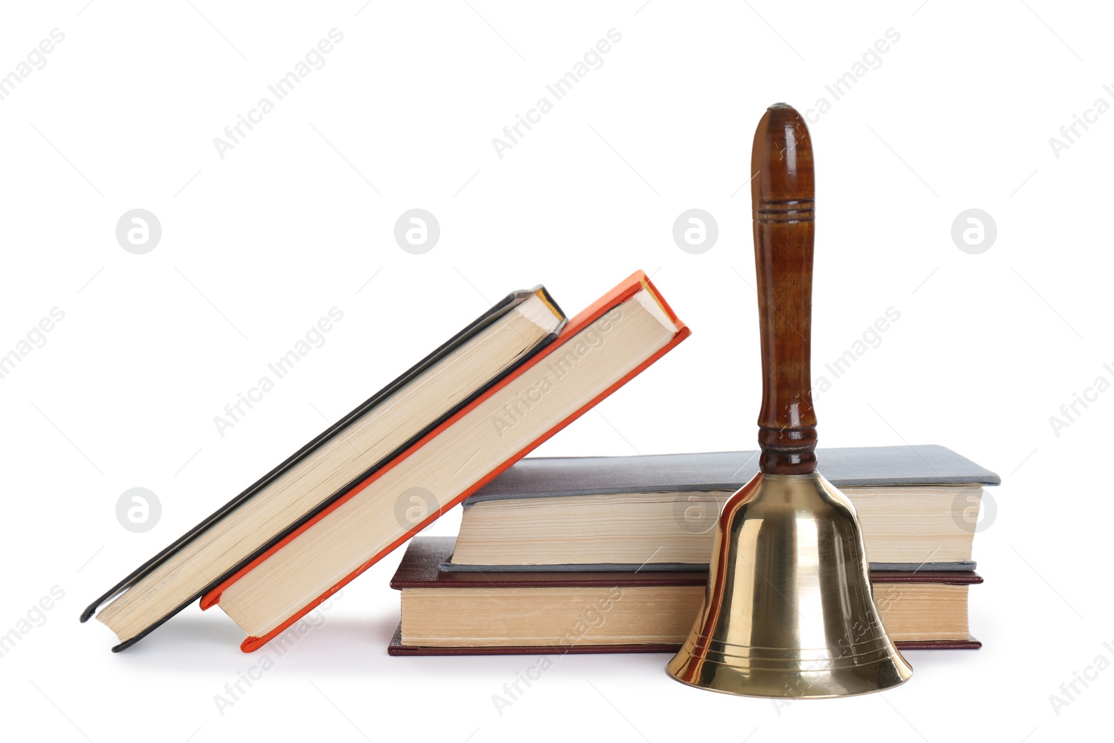 Photo of Golden school bell with wooden handle and books on white background