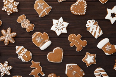 Photo of Many different delicious Christmas cookies on wooden table, flat lay