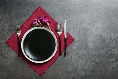 Photo of Stylish elegant table setting on color background, top view. Space for text