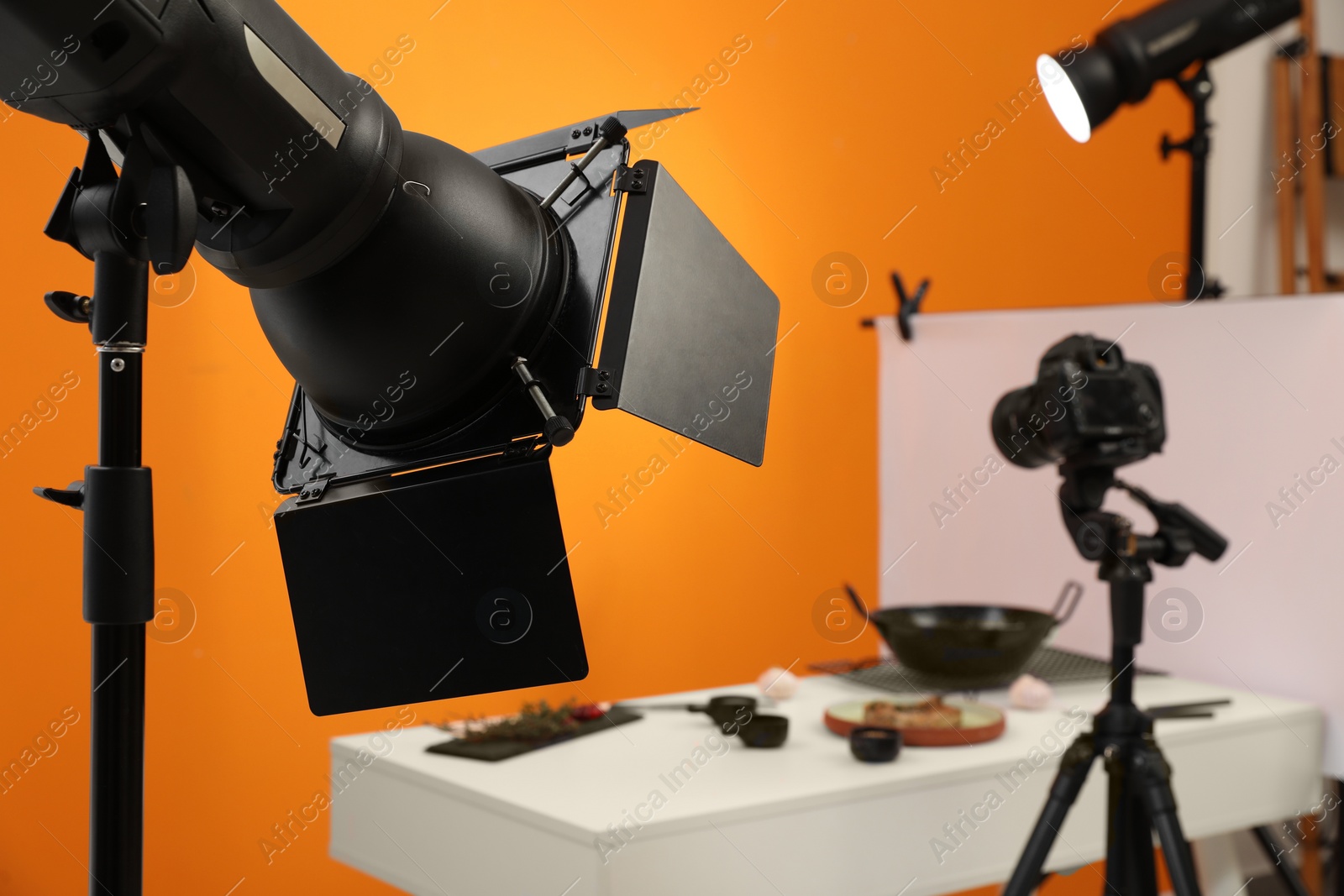Photo of Professional equipment and composition with tasty dish on white table in studio, space for text. Food photography