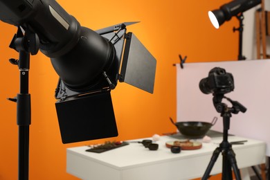 Photo of Professional equipment and composition with tasty dish on white table in studio, space for text. Food photography