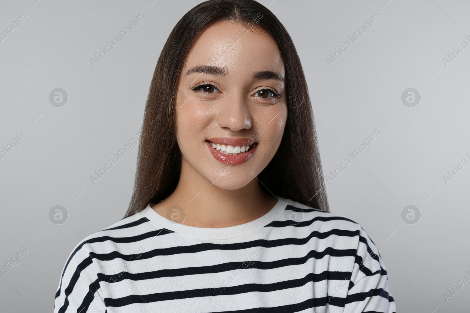 Photo of Portrait of beautiful young woman on light grey background