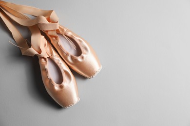 Ballet shoes. Elegant pointes on grey background, flat lay. Space for text