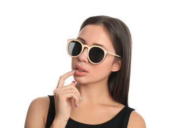 Beautiful young woman wearing sunglasses on white background