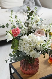 Bouquet of beautiful flowers on wooden table indoors