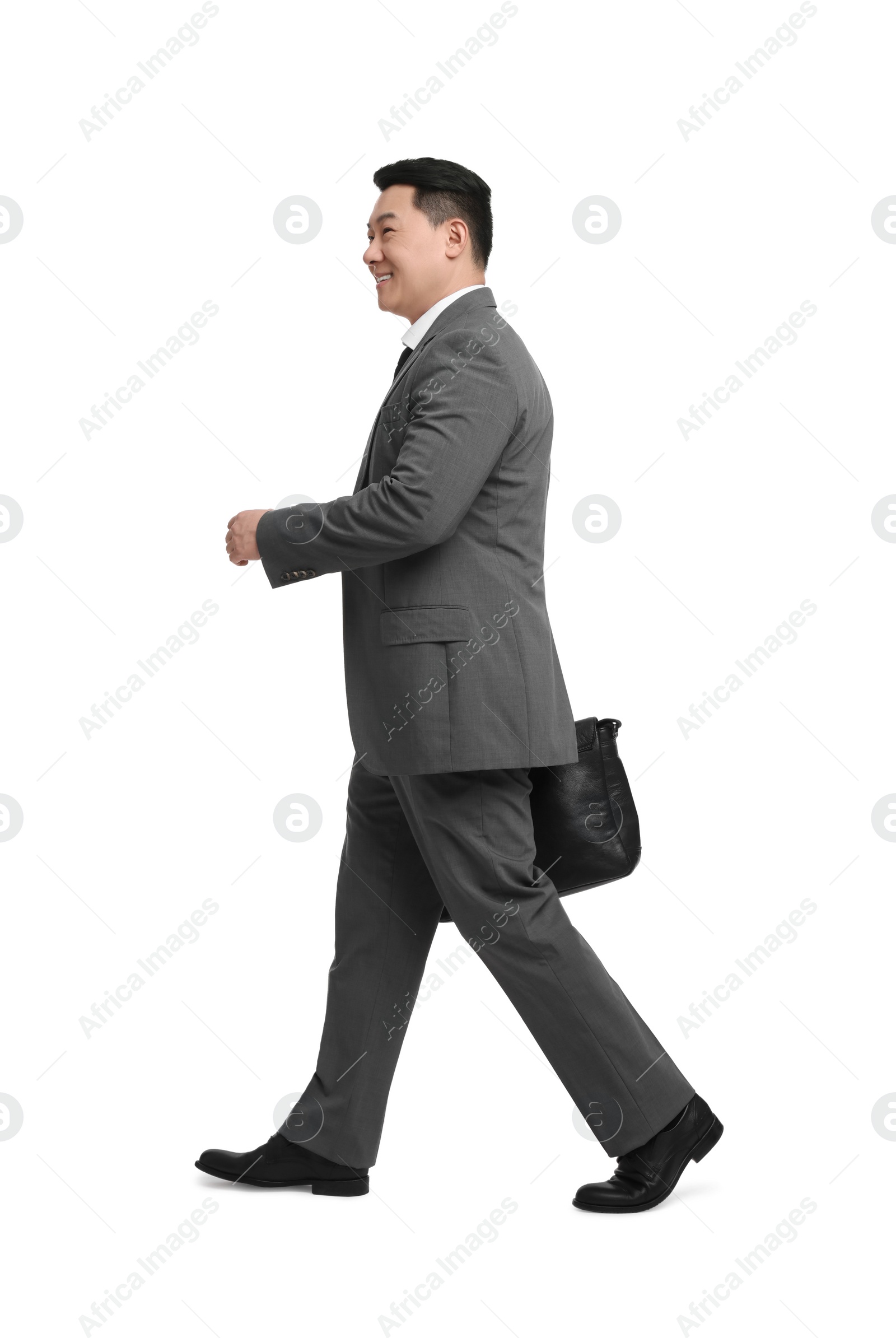 Photo of Businessman with briefcase walking on white background