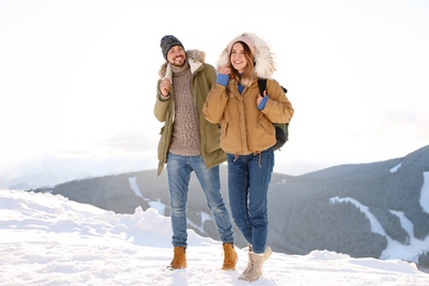 Happy couple spending winter vacation together in mountains