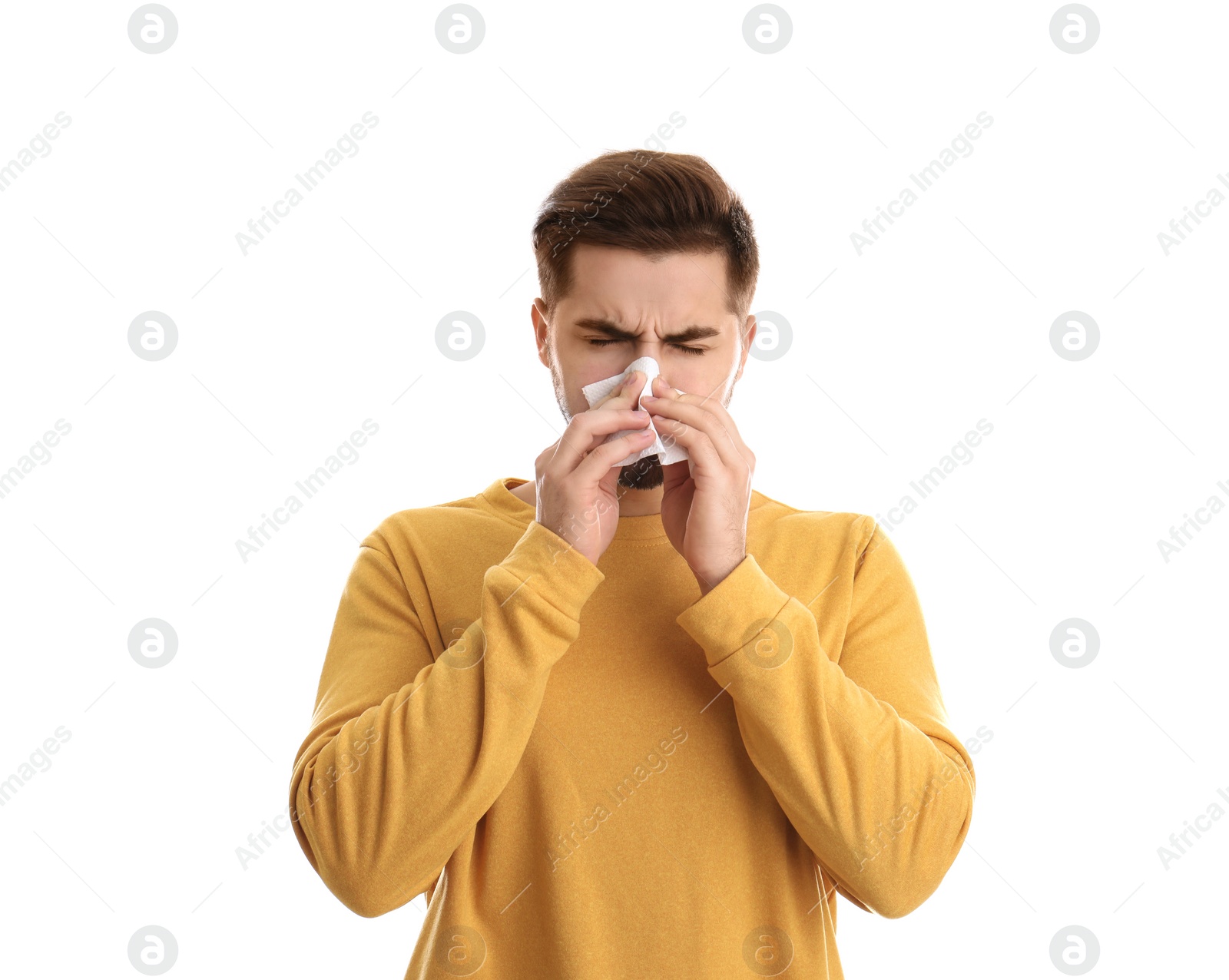 Photo of Handsome young man blowing nose against white background