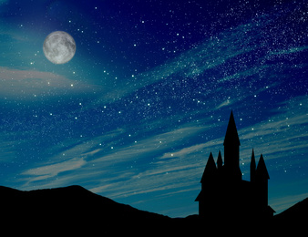 Image of Fairy tale. Magnificent castle under starry sky with full moon at night