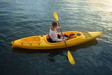 Photo of Young woman kayaking in river. Summer activity