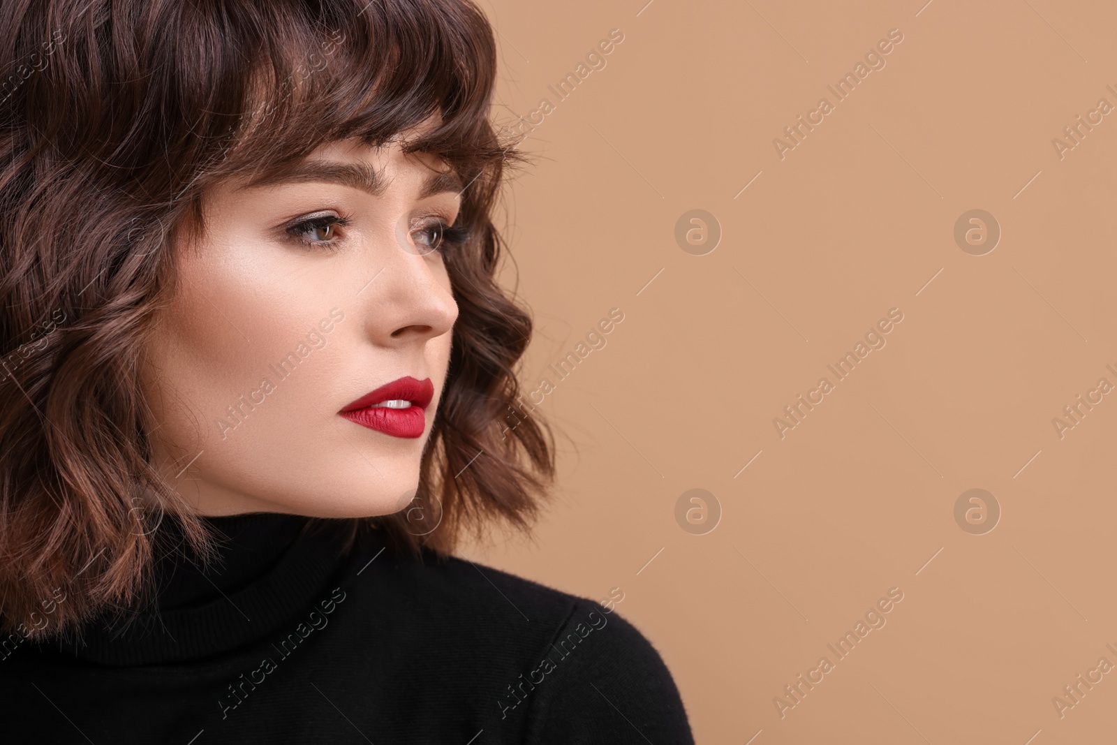 Photo of Beautiful young woman with wavy hairstyle on beige background. Space for text