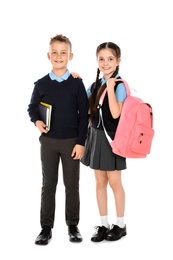 Full length portrait of cute children in school uniform on white background