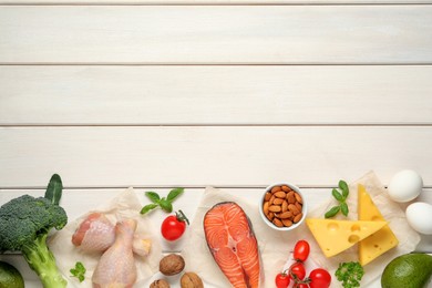 Photo of Flat lay composition with different fresh products on white wooden table, space for text. Keto diet