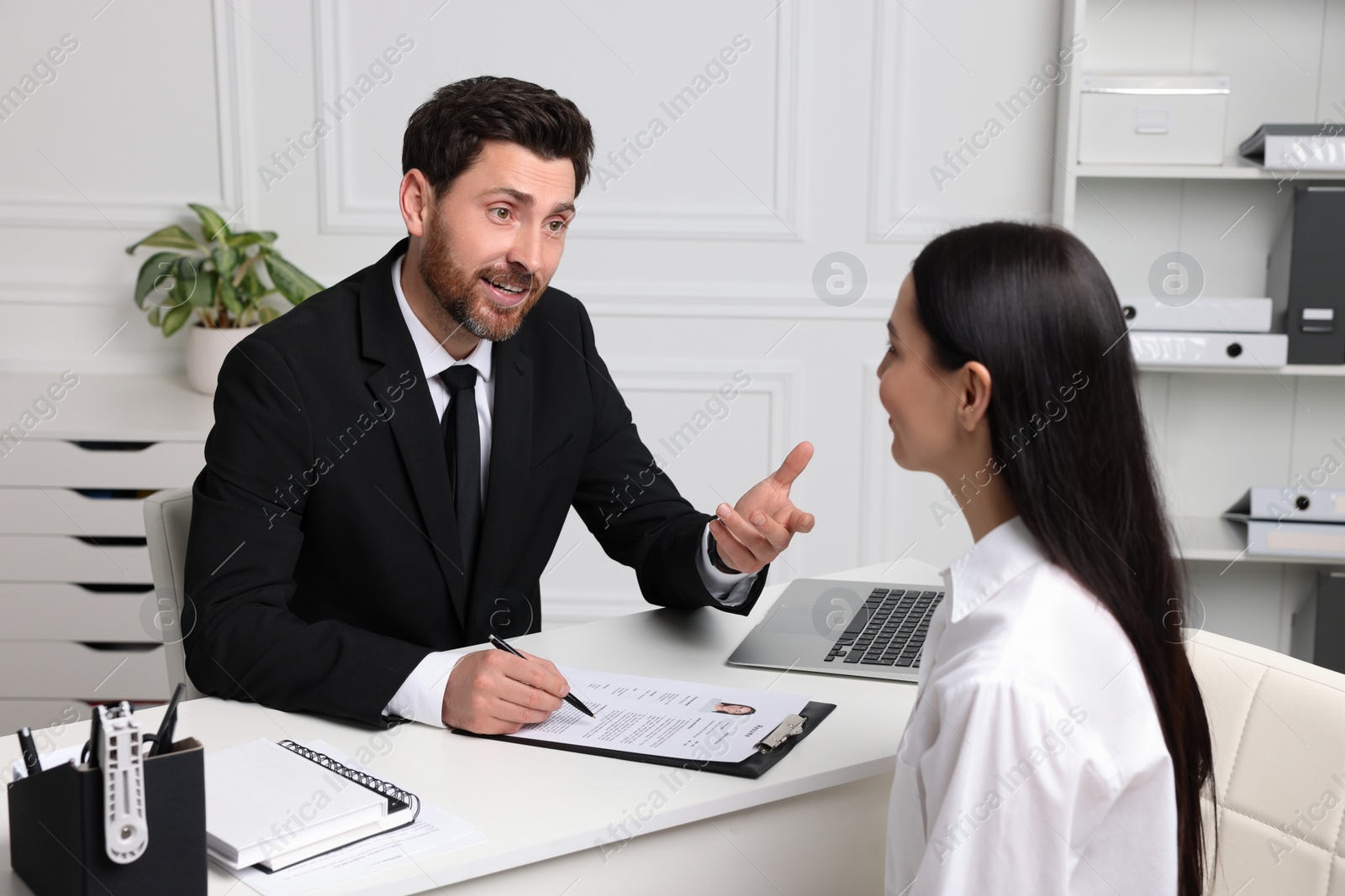 Photo of Human resources manager conducting job interview with applicant in office