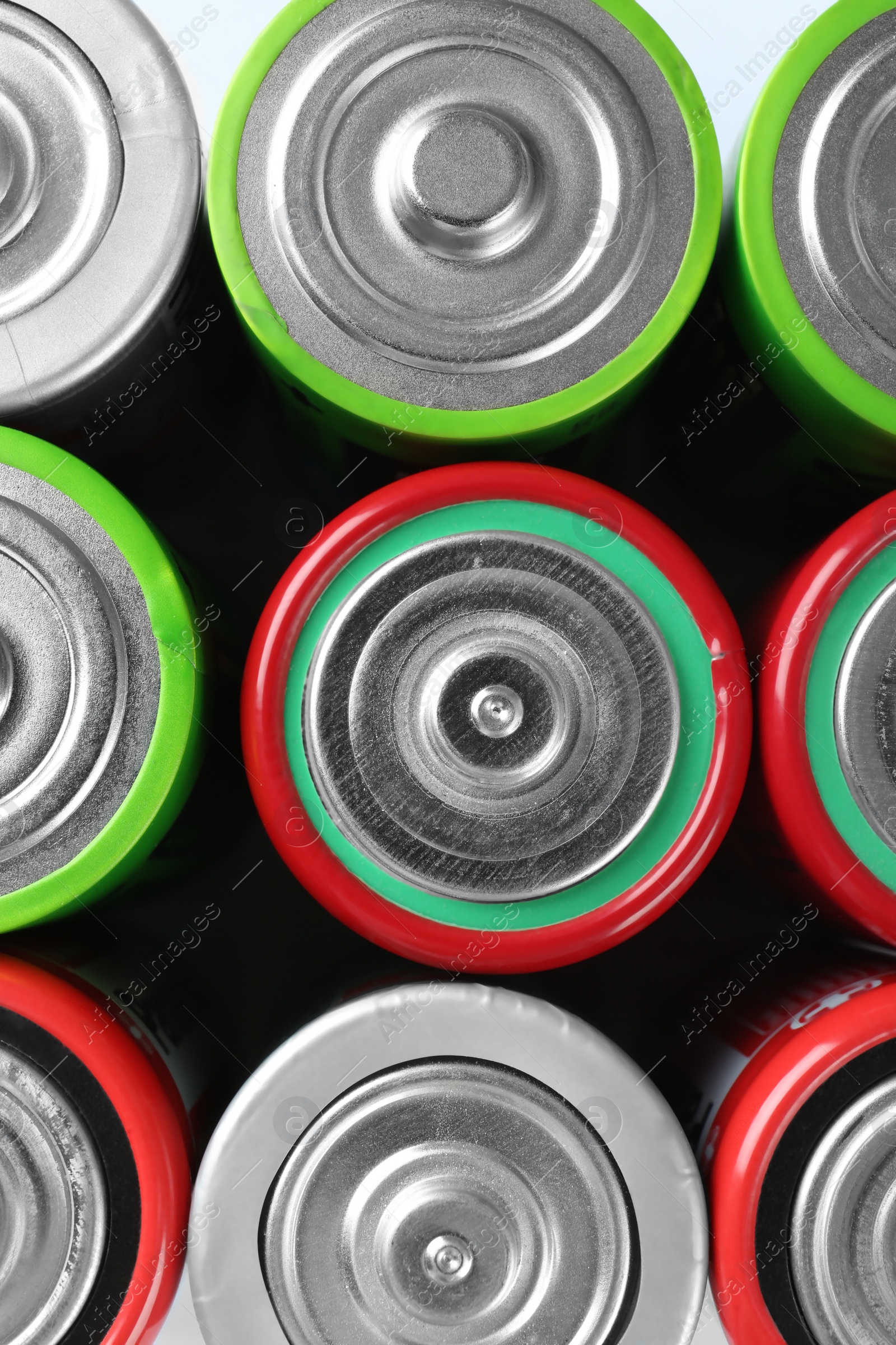 Photo of Many different batteries as background, top view