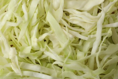 Photo of Chopped white cabbage as background, closeup view