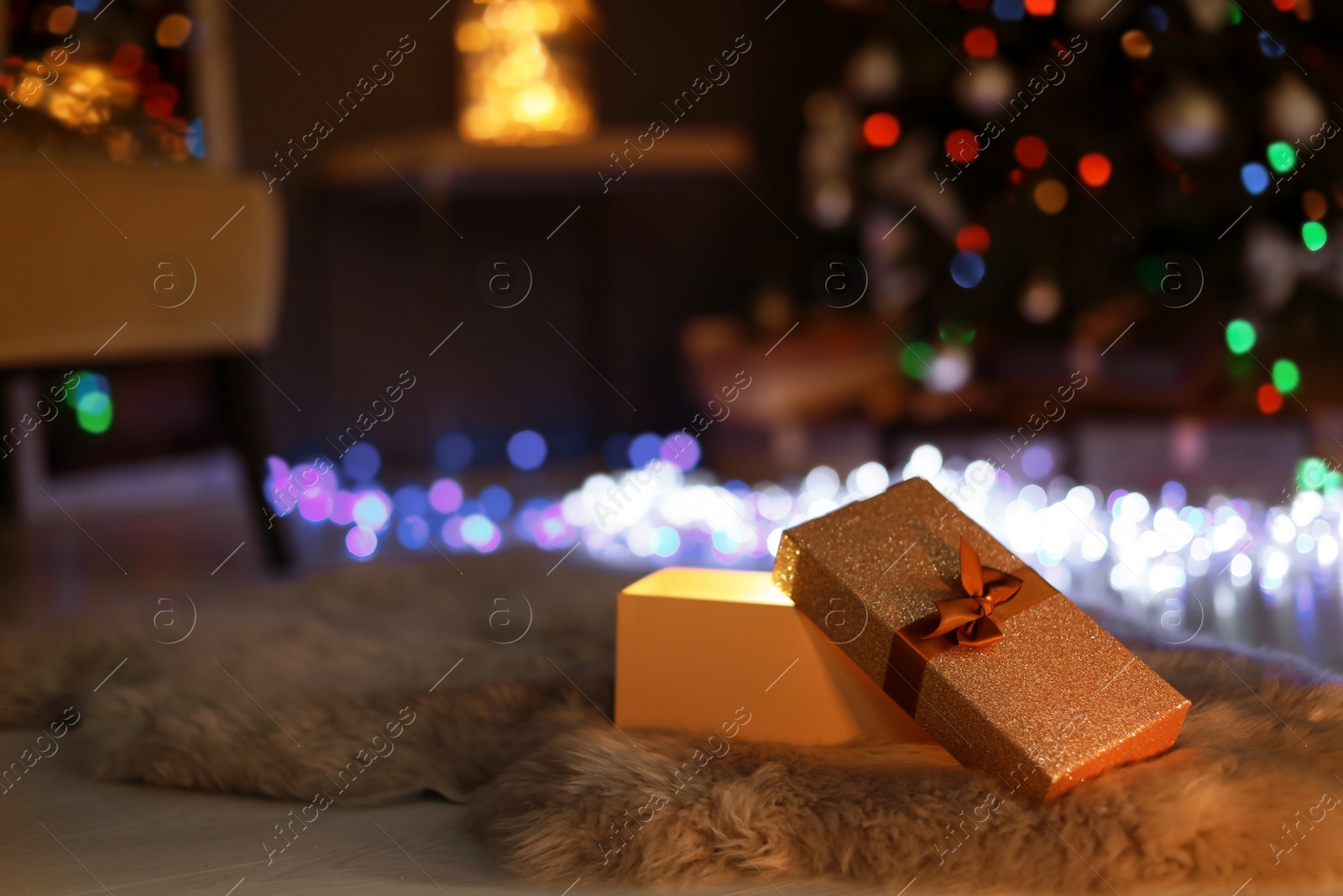 Photo of Open gift box and Christmas tree in dark room