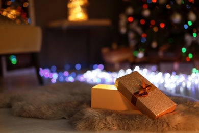 Open gift box and Christmas tree in dark room