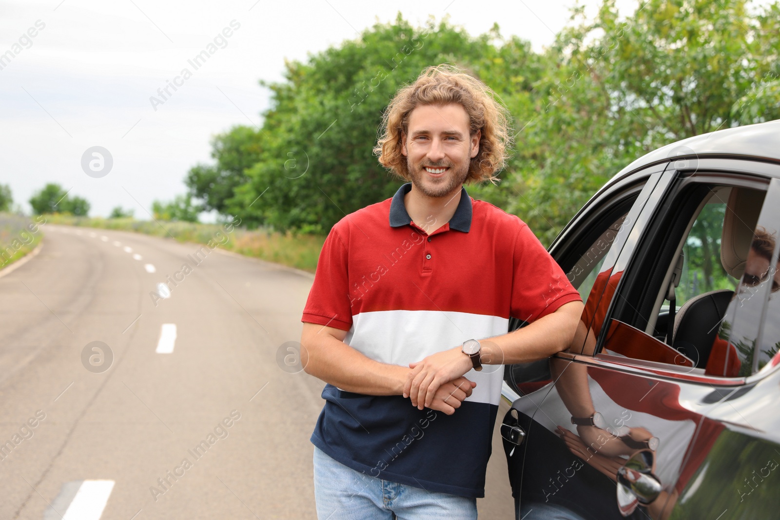 Photo of Attractive young man near luxury car outdoors