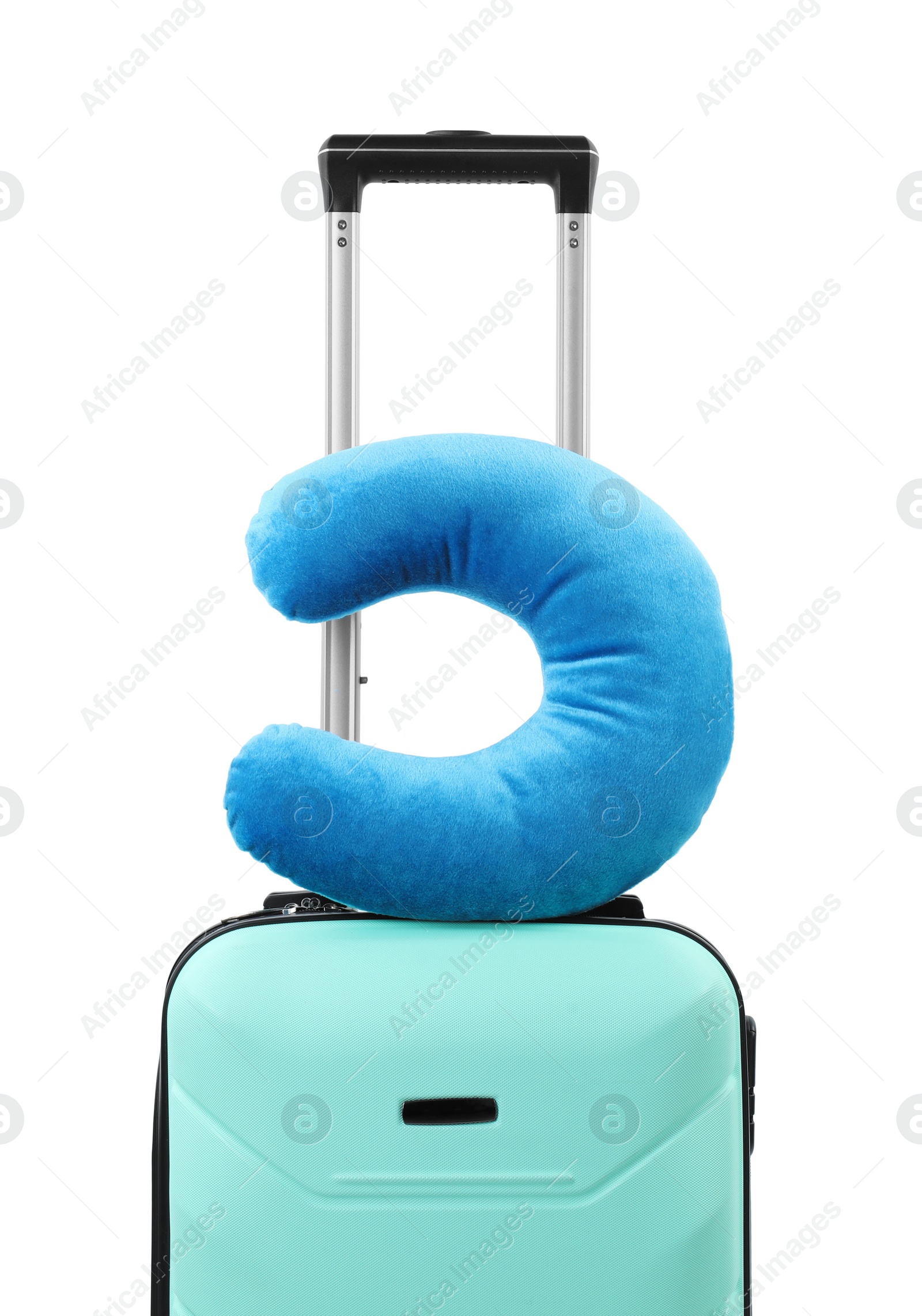 Photo of Soft travel pillow on turquoise suitcase isolated on white