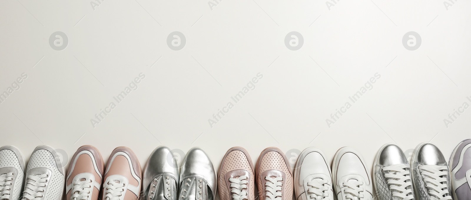 Photo of Flat lay composition with stylish shoes on light background. Space for text