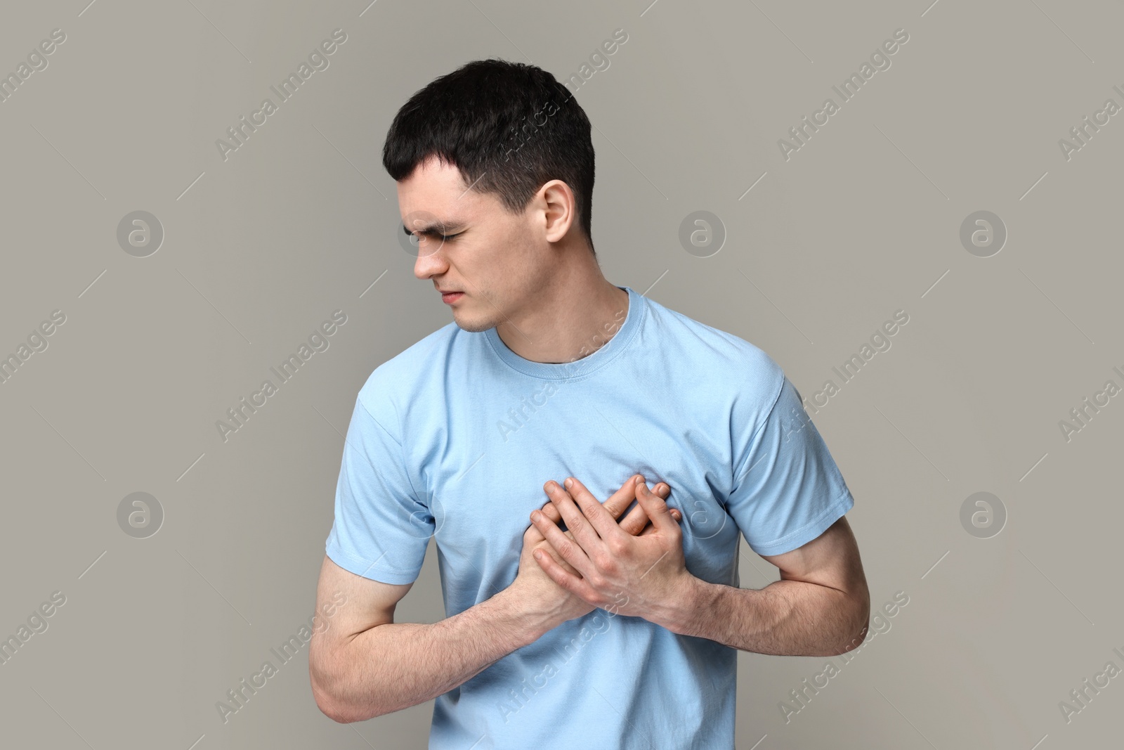 Photo of Man suffering from heart hurt on grey background