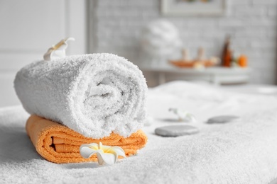 Towels on massage table in spa salon