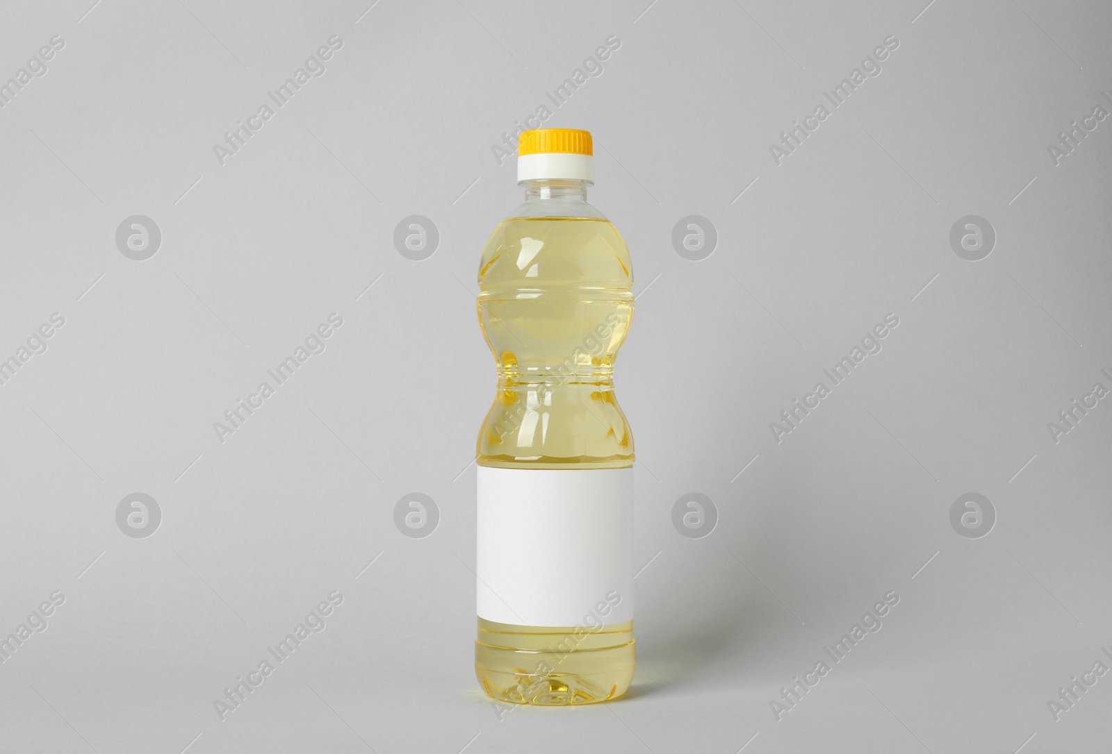 Photo of Bottle of cooking oil on light grey background