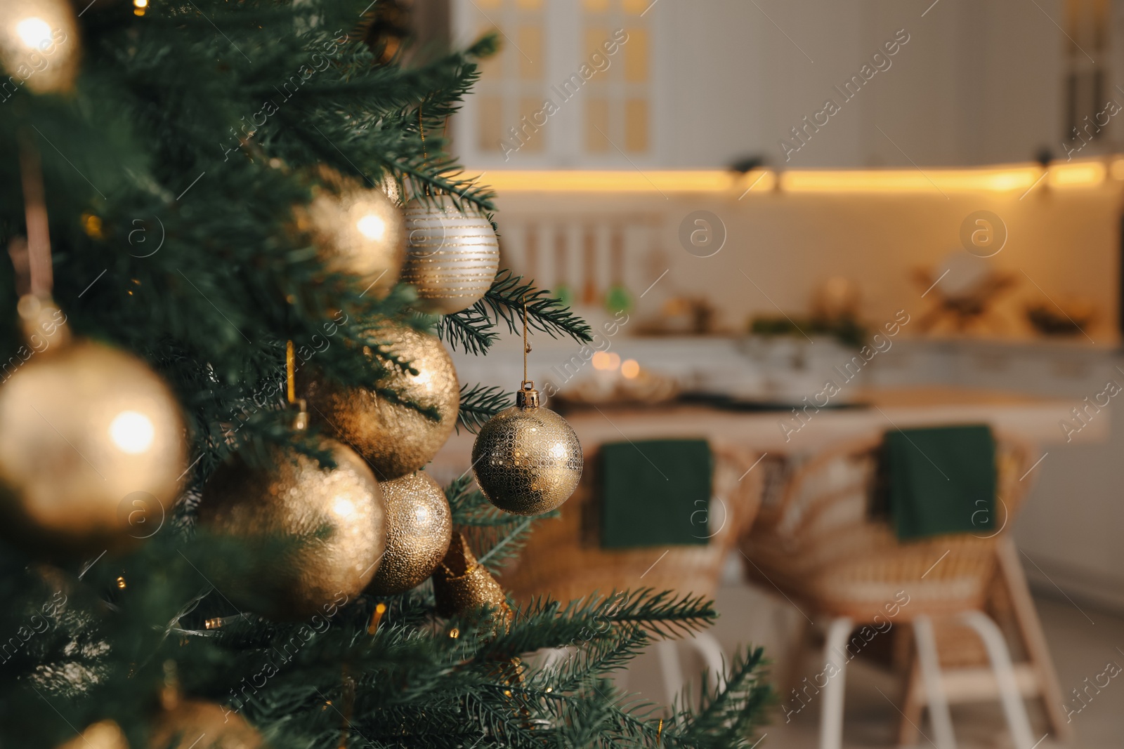 Photo of Beautiful Christmas tree in spacious kitchen, closeup. Space for text