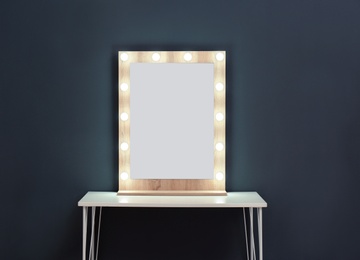 Table with mirror near color wall. Dressing room interior