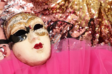 Photo of Carnival mask and beautiful pink costume with sequins, above view