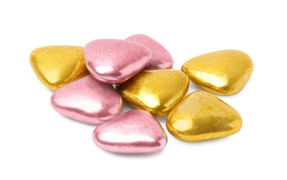 Many delicious heart shaped candies on white background