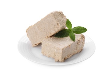 Plate with pieces of tasty halva and mint isolated on white