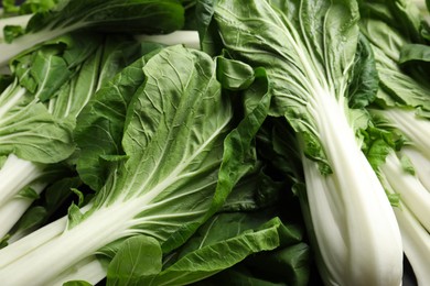 Photo of Fresh green pak choy cabbages as background, closeup