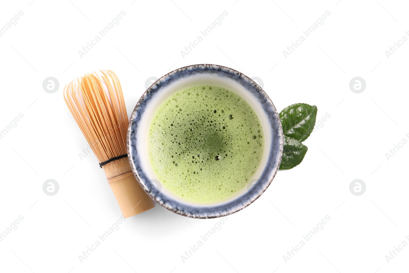 Photo of Cup of matcha tea and bamboo whisk isolated on white, top view
