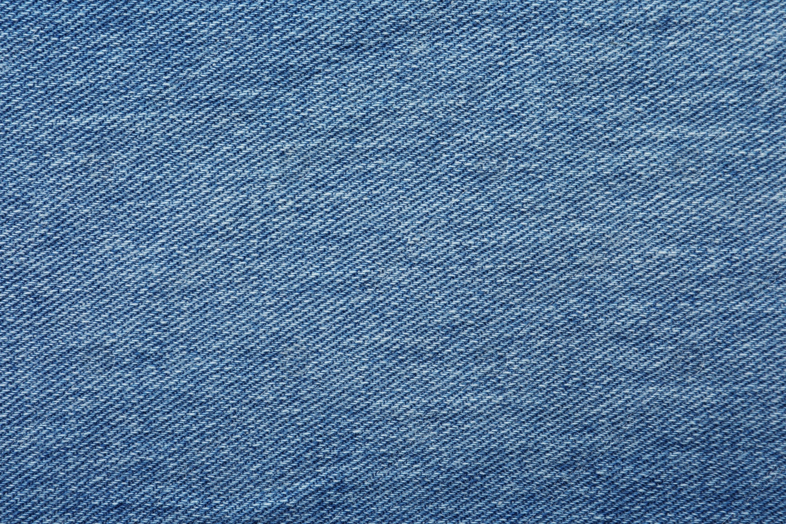 Photo of Texture of blue jeans as background, closeup