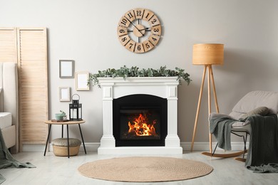 Photo of Stylish room decorated with beautiful eucalyptus garland on fireplace