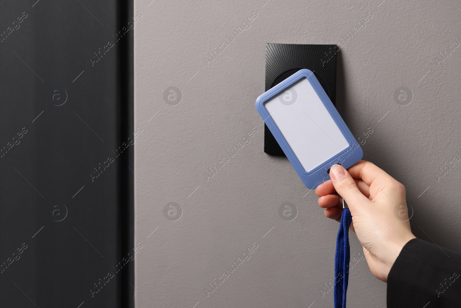 Photo of Woman unlocking door with key card, closeup