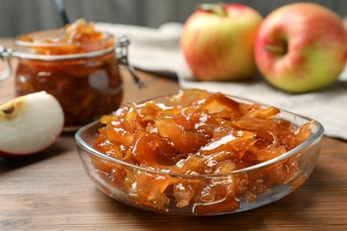 Photo of Tasty apple jam and fresh fruit on wooden table, closeup