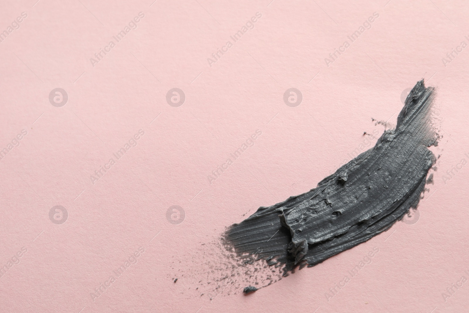 Photo of Sample of face mask on pink background, top view. Space for text