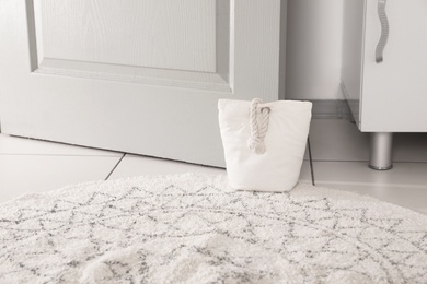 Photo of Stuffed bag holding wooden door at home