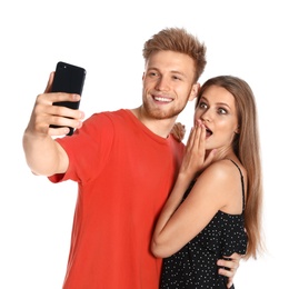 Photo of Happy young couple taking selfie on white background