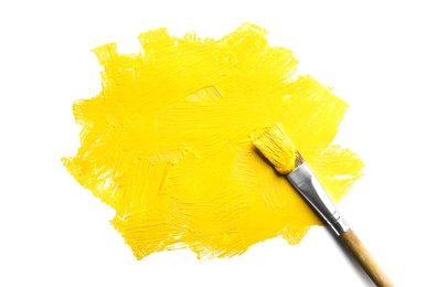 Photo of Paint stroke and brush on white background, top view