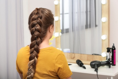 Photo of Woman with braided hair in professional salon