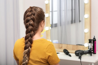 Woman with braided hair in professional salon